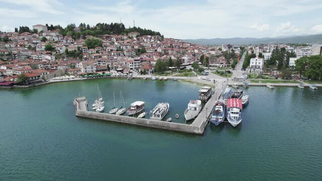 Aerial view of Ohrid. Different sail boats beside dock on ohrid lake with traditional house architecture on background