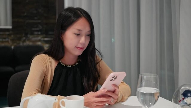 Woman use of cellphone in restaurant