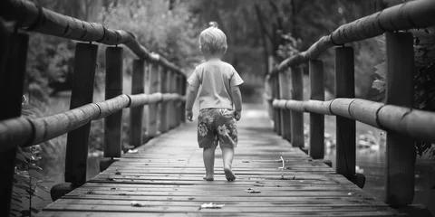 Foto op Plexiglas A young boy walking across a rustic wooden bridge. Suitable for nature and outdoor themes © Fotograf