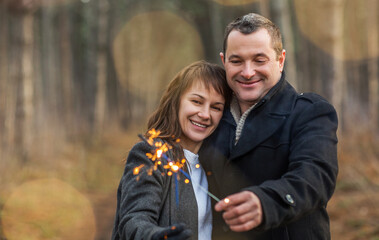 Happy couple hugging in winter park