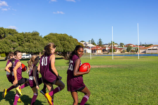 children in football team training on playing field