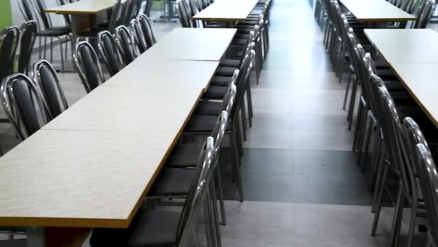 Cafeteria or canteen interior. School cafeteria. Factory canteen with chairs and tables, nobody. Modern cafeteria interior. Clean canteen in modern school. Lunch room.