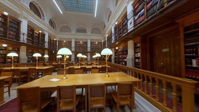 Classic/Historic Reading Room in Library with Rows of Wooden Tables and Lamps indoor aerial fpv drone footage