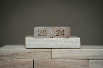 number 2024 bearing wooden blocks with gray background. Concept of a calendar year of 2024. 