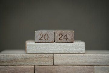 number 2024 bearing wooden blocks with gray background. Concept of a calendar year of 2024. 