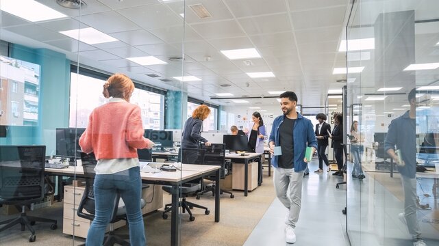 Diverse colleagues entering creative workspace