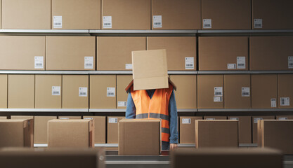 Frustrated warehouse worker with a box on her head - 784413068