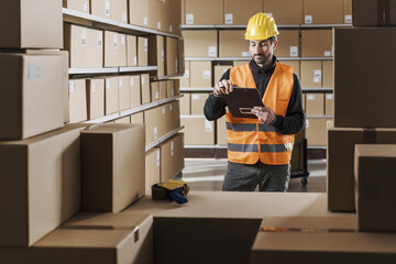 Warehouse worker checking orders and packages - 784414861