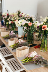 Fototapeta na wymiar Floral arrangement workspace with fresh cut flowers.