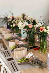 Floral arrangement workspace with fresh cut flowers.