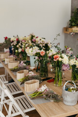 Floral arrangement workspace with fresh cut flowers.