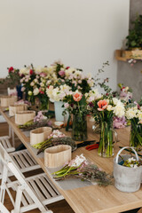 Fototapeta na wymiar Floral arrangement workspace with fresh cut flowers.