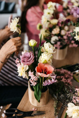 Obraz na płótnie Canvas Artful floral composition in the making at a floral workshop scene.