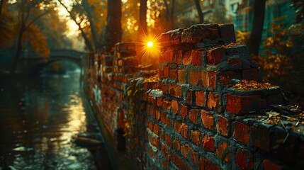   A brick wall by a body of water Sun shines through trees beyond