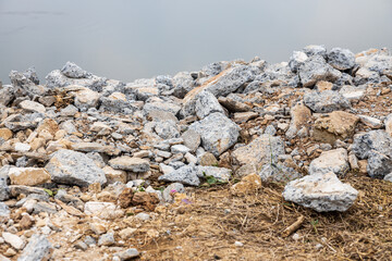 Close-up view: Piles of broken concrete debris taken from road demolition are left on a mound.