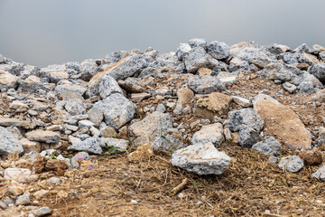 Close-up view: Piles of broken concrete debris taken from road demolition are left on a mound.