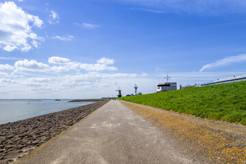 Scenic View of Windmills and Pathway by the Sea