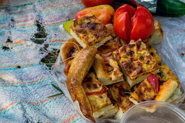 Lunch in the countryside in nature meat homemade pizza vegetables close-up