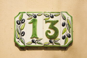 Close up view of ceramic address plate with number 13