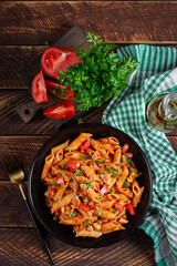 Classic italian pasta penne arrabbiata with vegetables on wooden table. Penne pasta with sauce arrabbiata. Top view, overhead - 784438255