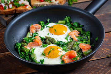 Keto breakfast. Fried eggs  with asparagus, spinach and salmon. - 784438664
