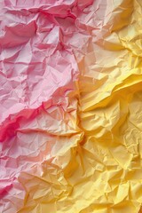 Close up of yellow and pink crumpled paper. Ideal for backgrounds or texture use