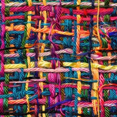 Close up of vibrant multicolored yarn weave, suitable for textile or crafting concepts