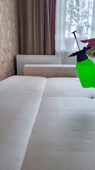 A specialist sprays cleaning agent on an office chair to remove stains. General cleaning.