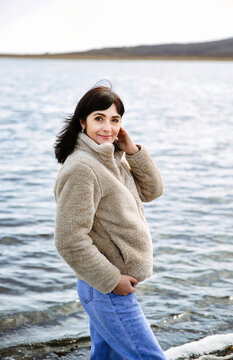 49 year old Russian woman smiling, looking at the camera on an early spring  day