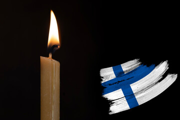 mourning candle burning front of flag Finland, memory of heroes served country, grief over loss,...