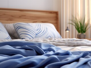 Close up view of a bed with a blue comforter, perfect for home decor websites or interior design blogs