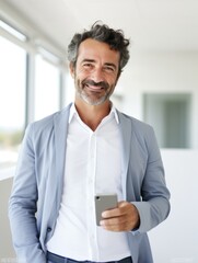 A happy man holding a cell phone