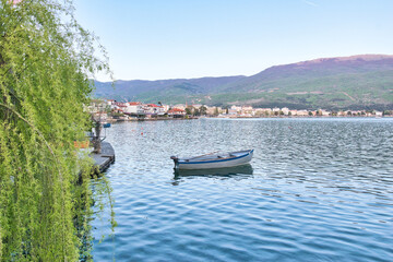 Fototapeta na wymiar Lake Ohrid, North Macedonia, April 13 2024. Mountain range and peninsula in distance. Ohrid Lake, Macedonia, Europe. The clear mesmerizing waters of lake Ohrid with a beautiful view. 