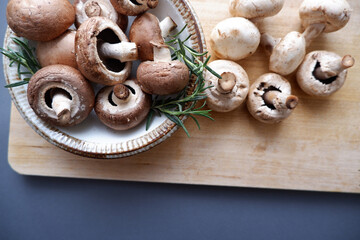 Champignon mushroom on the wooden table. healthy food concept decoration background. Mushrooms composition on wooden plate. 