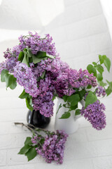 A bouquet of lilac in a white vase
