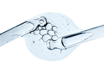 Two pipettes and a drop of cosmetic serum for the skin. Liquid body care product. Macrophotography....