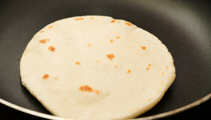 Making sourdough leavened pita-like flatbread on dry frying pan
