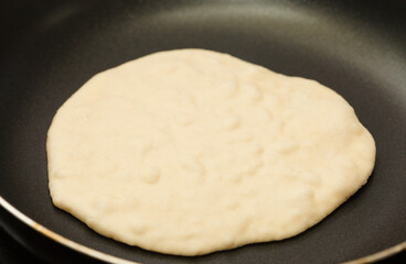 Making sourdough leavened pita-like flatbread on dry frying pan
