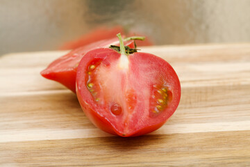 Round Pink tomato with a nose that produces heart shape when cut in half