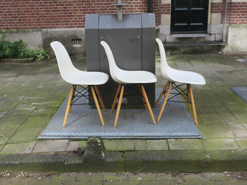 three white chairs in a row