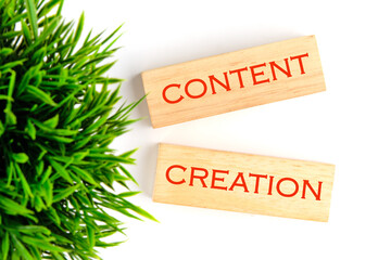 Concept word Content creation on wooden blocks on a white background, top view