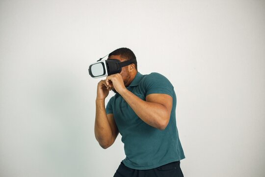 Fototapeta Black guy with virtual reality glasses isolated on white background