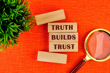 Truth builds trust symbol. Concept words Truth builds trust on wooden blocks on a red background...