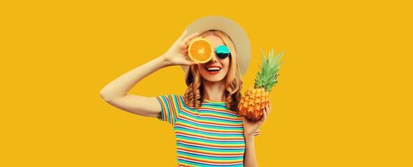 Summer vacation portrait of happy woman with fresh tropical juicy fruits on yellow background