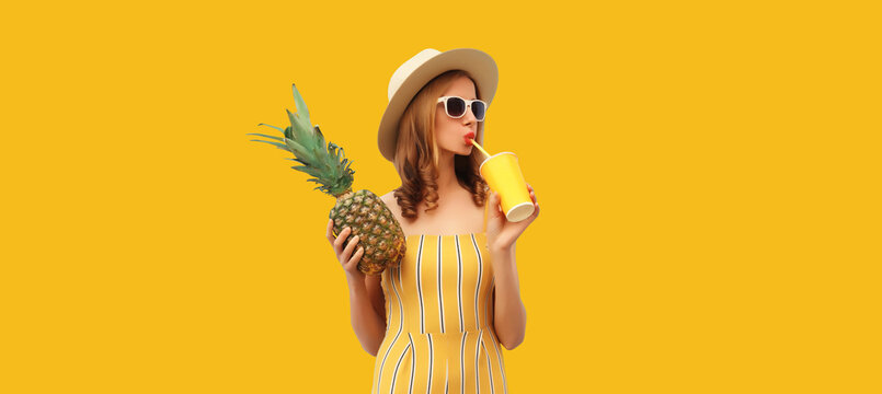 Summer portrait of stylish young woman drinking fresh juice with pineapple fruit