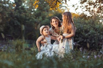 Mother and daughters enjoying a sunny weather in nature