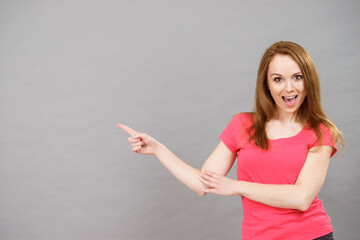 Woman pointing, surprised face expression