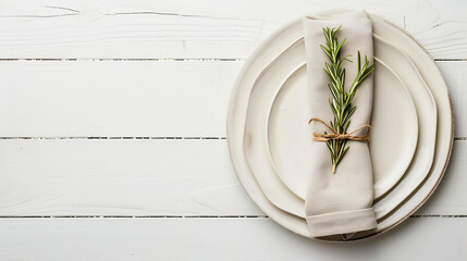 Plain wooden table setting with napkin against white backdrop.