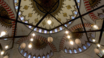 Fototapeta na wymiar Decorations and Quranic verses inside the Sharjah Grand Mosque