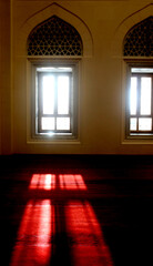 Sunlight enters through a window in the Sharjah Grand Mosque